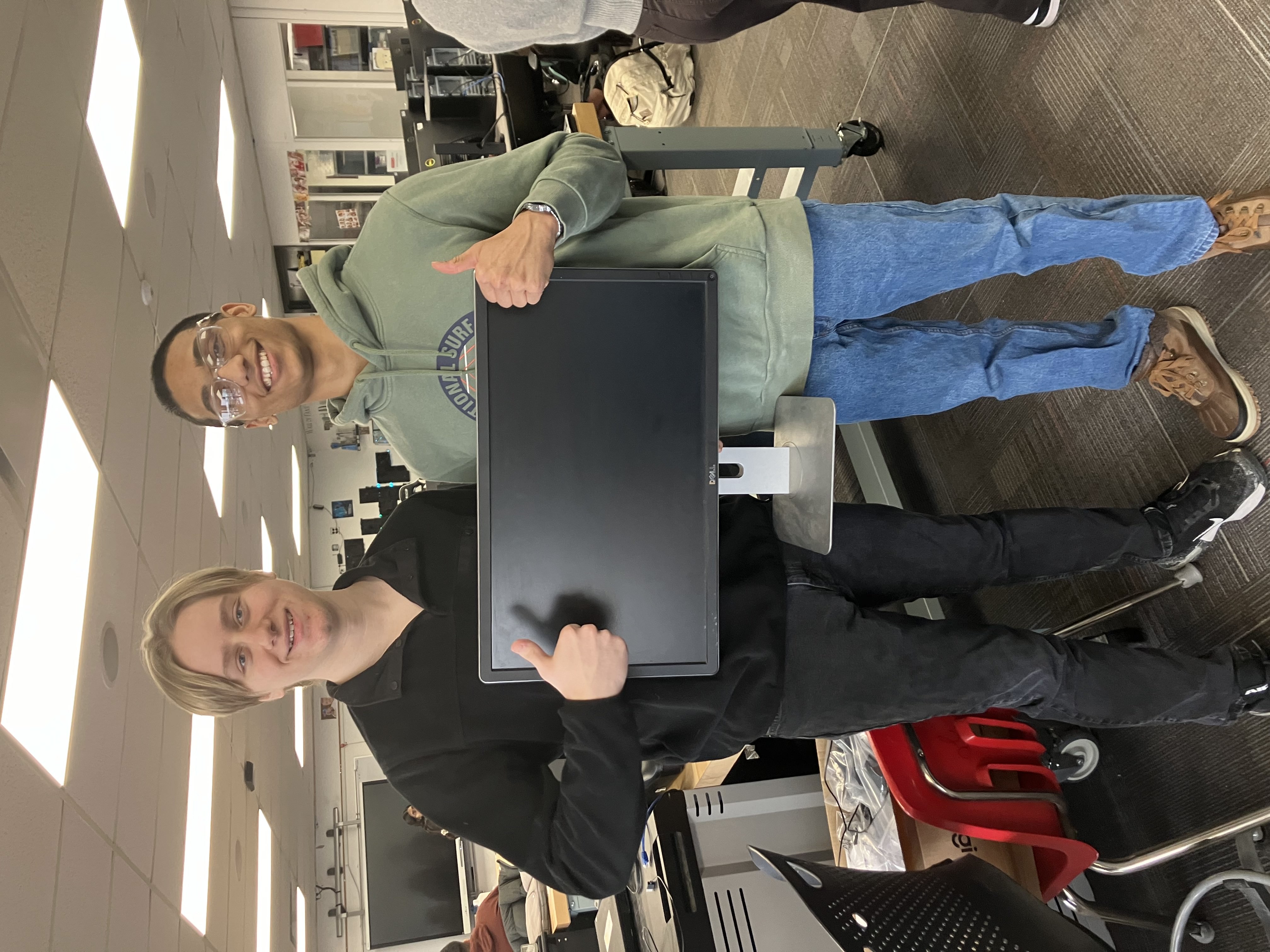 Image of a student working on fixing a computer