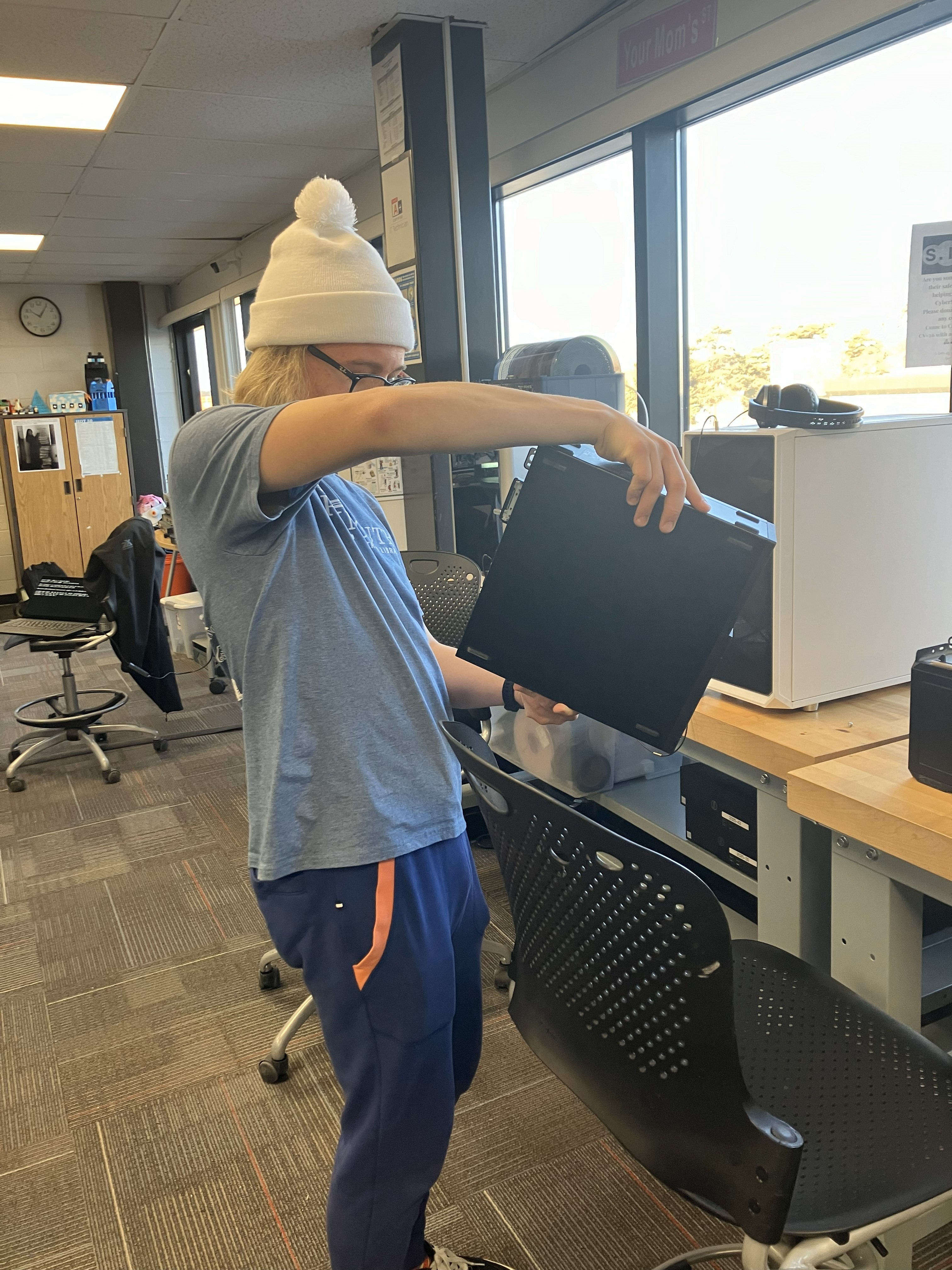 Image of Mr. Obsniuk and a student fixing hardware.